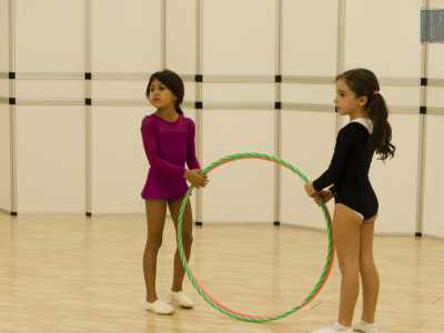 Aurora ed Angelica tengono contemporaneamente in mano due cerchi, uno verde e uno arancione